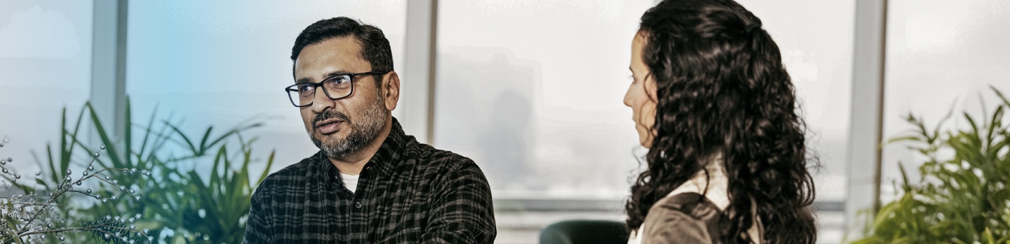 Two people discussing around a small table